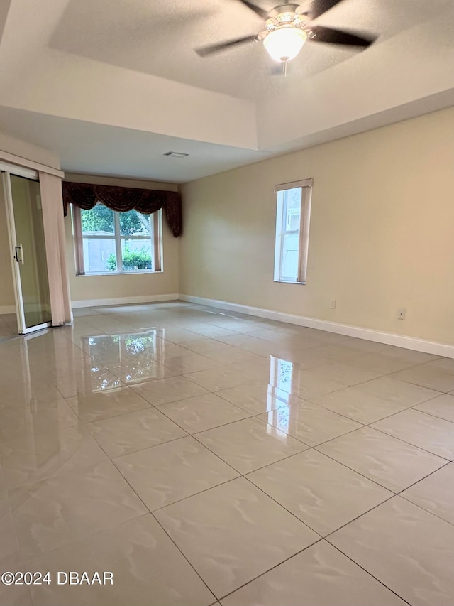 5 Wild Rose Pl, Palm Coast, FL 32164 - empty room with a tray ceiling and ceiling fan