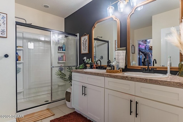 2756 Star Coral Ln, New Smyrna Beach, FL 32168 - full bathroom with a shower stall, double vanity, tile patterned floors, and a spacious closet