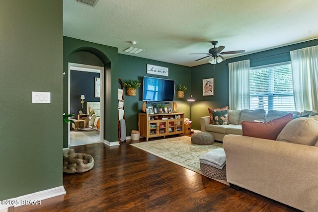 2756 Star Coral Ln, New Smyrna Beach, FL 32168 - living area with arched walkways, wood finished floors, a ceiling fan, baseboards, and a textured ceiling