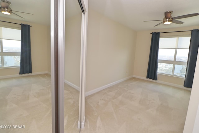 carpeted empty room with ceiling fan