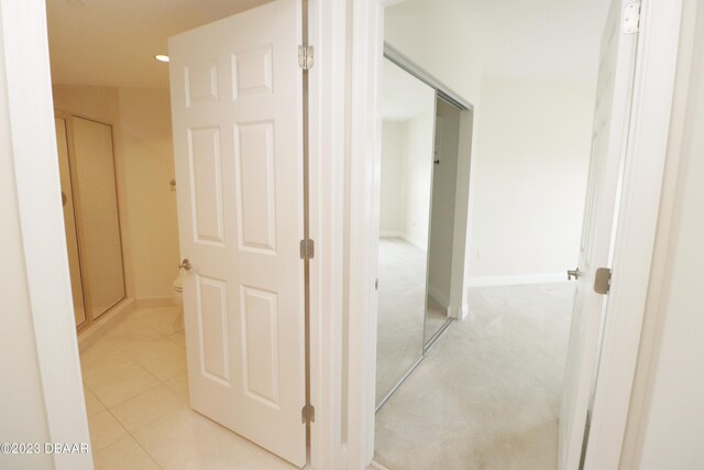 bathroom with walk in shower, tile patterned flooring, and vanity