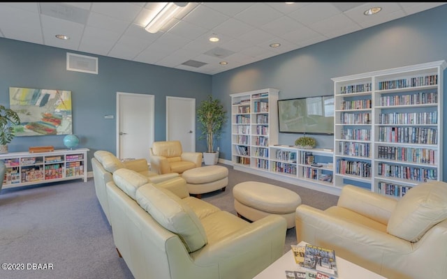 carpeted living room featuring visible vents, recessed lighting, and a paneled ceiling