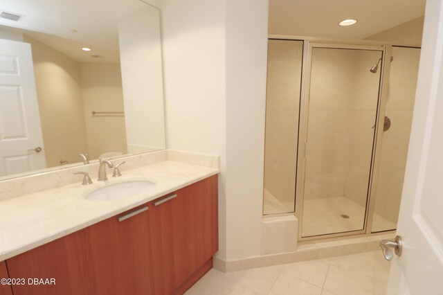 full bath with tile patterned floors, recessed lighting, a stall shower, and vanity