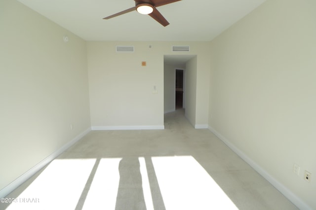 carpeted spare room with ceiling fan