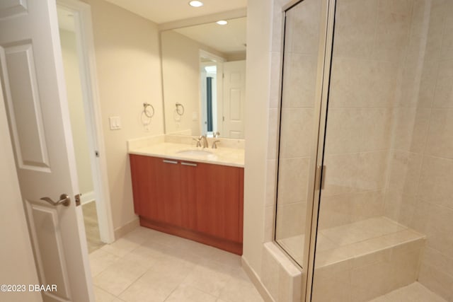 bathroom featuring vanity, a shower with shower door, and tile patterned floors