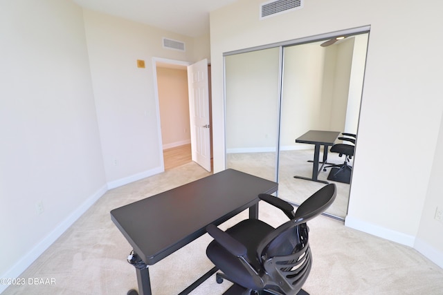 workout area featuring light colored carpet