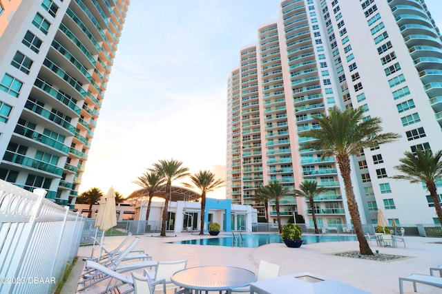 231 Riverside Dr Unit 2409, Holly Hill, FL 32117 - view of property with a community pool and fence