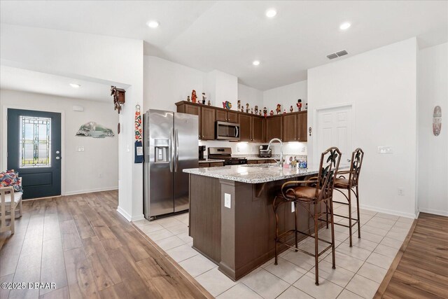 20 Willow St, Palm Coast, FL 32164 - kitchen with light wood-style flooring, a sink, visible vents, and stainless steel appliances