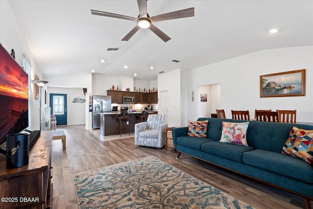 20 Willow St, Palm Coast, FL 32164 - living area featuring light wood-style floors, visible vents, vaulted ceiling, and a ceiling fan