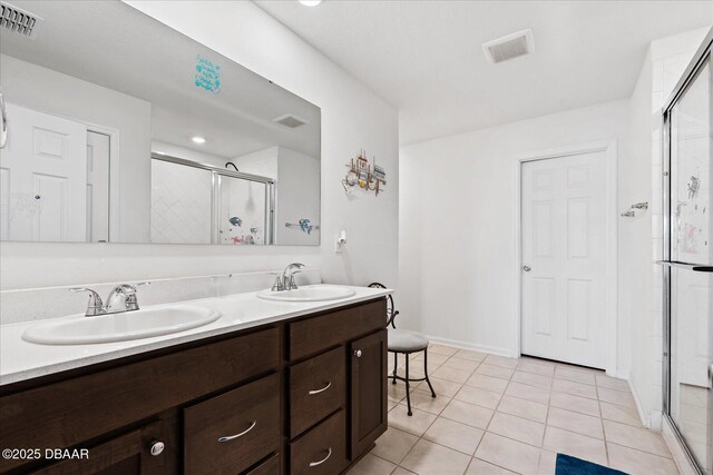 20 Willow St, Palm Coast, FL 32164 - bathroom with a stall shower, double vanity, a sink, and visible vents