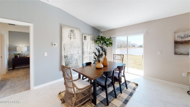 3988 Willowbrook Dr, Edgewater, FL 32141 - dining area featuring lofted ceiling, light tile patterned floors, baseboards, and a water view