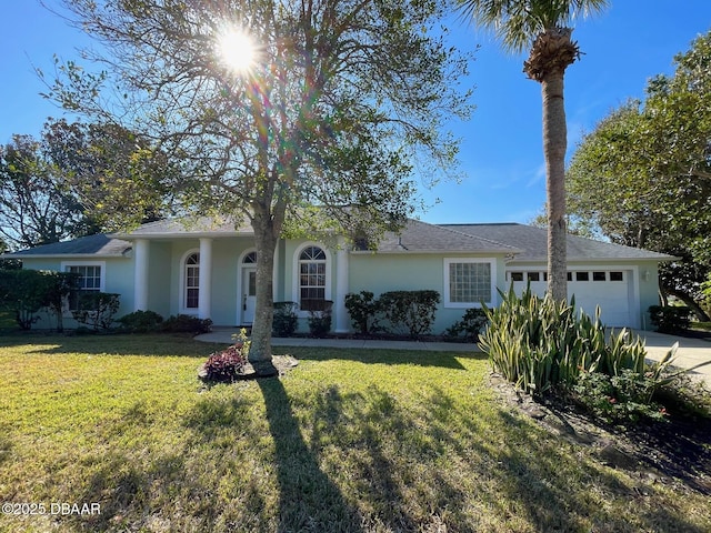 ranch-style home featuring a garage and a front lawn