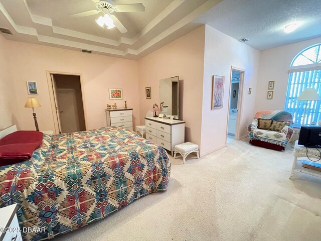 carpeted bedroom with ceiling fan, a closet, and a textured ceiling