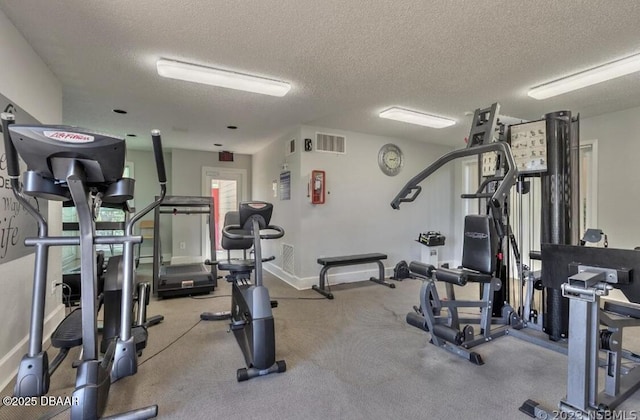 exercise room featuring a textured ceiling