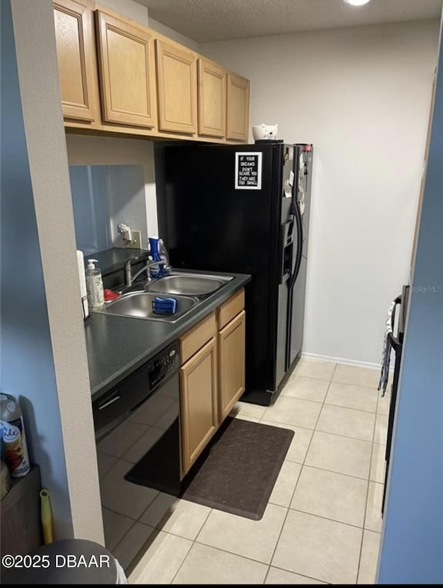 kitchen with sink, black dishwasher, light brown cabinets, and light tile patterned floors