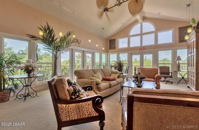 sunroom / solarium featuring lofted ceiling, ceiling fan, and french doors