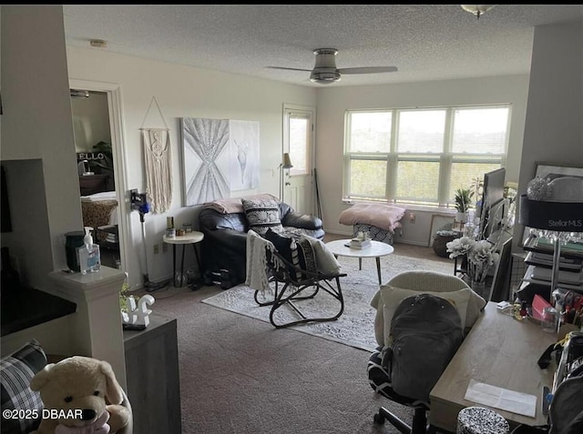 living room with carpet flooring, a textured ceiling, and ceiling fan