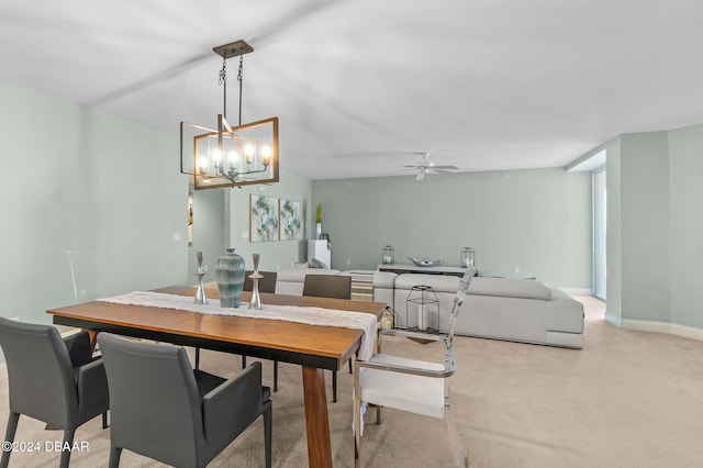 dining area featuring ceiling fan with notable chandelier and light colored carpet