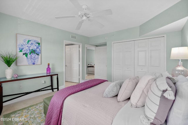 carpeted bedroom with ceiling fan and a closet