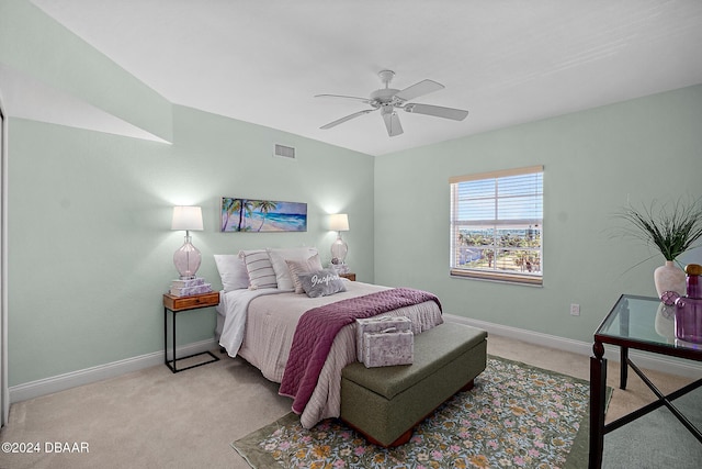 bedroom featuring light colored carpet and ceiling fan