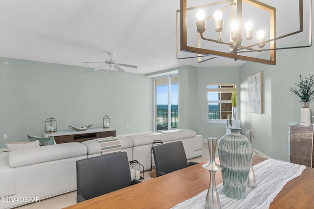 dining area with hardwood / wood-style floors and ceiling fan with notable chandelier