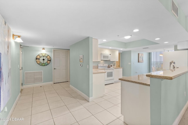 kitchen featuring kitchen peninsula, white cabinets, light tile patterned flooring, and white appliances