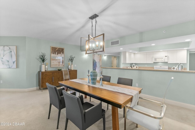 carpeted dining room featuring a notable chandelier