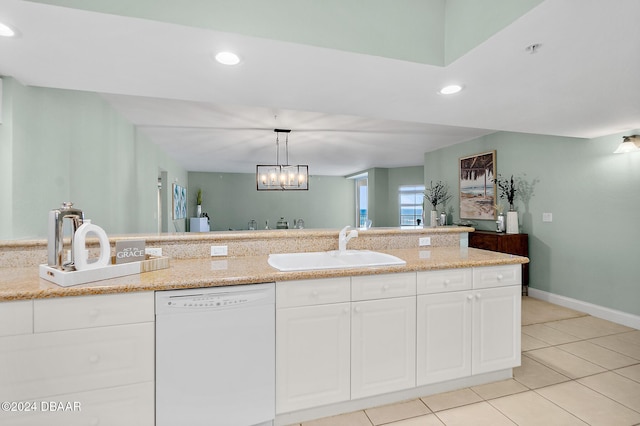 kitchen featuring dishwasher, white cabinets, and decorative light fixtures