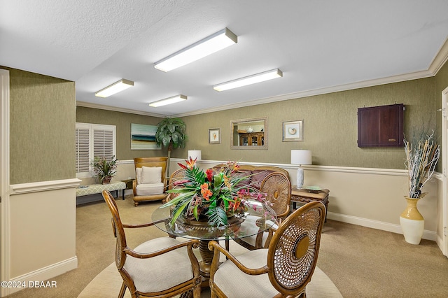 dining room featuring light carpet, a textured ceiling, and crown molding