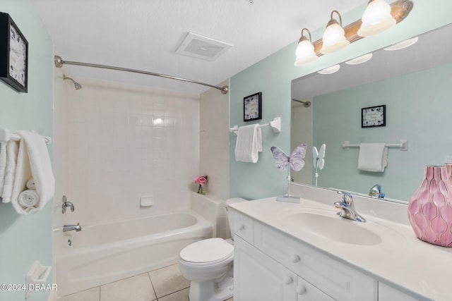 full bathroom featuring toilet, vanity, tiled shower / bath combo, and tile patterned floors