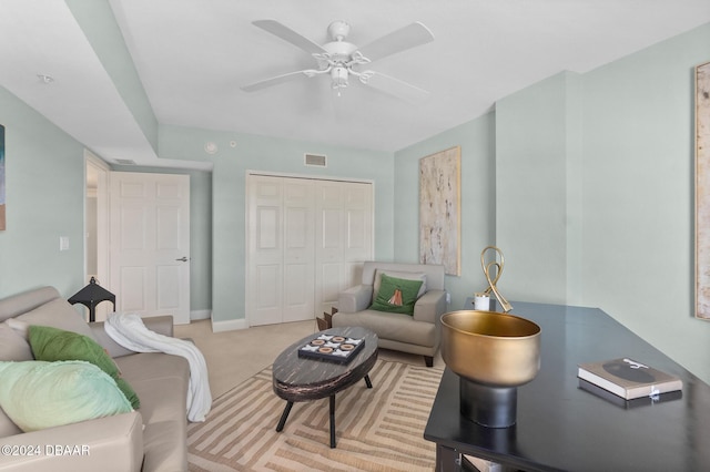 living room featuring ceiling fan and light colored carpet