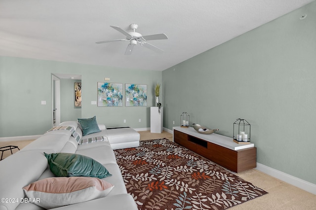 carpeted living room with ceiling fan