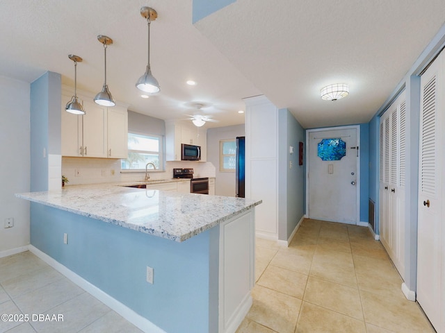 kitchen featuring appliances with stainless steel finishes, white cabinetry, light stone countertops, decorative light fixtures, and kitchen peninsula