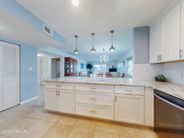 kitchen featuring white cabinetry, dishwashing machine, decorative backsplash, light tile patterned floors, and kitchen peninsula