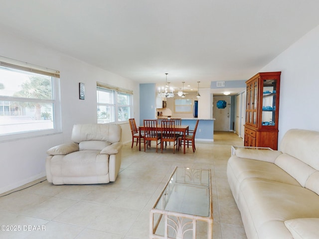 living room featuring an inviting chandelier and light tile patterned floors