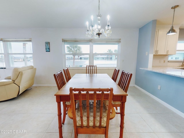 tiled dining area featuring an inviting chandelier