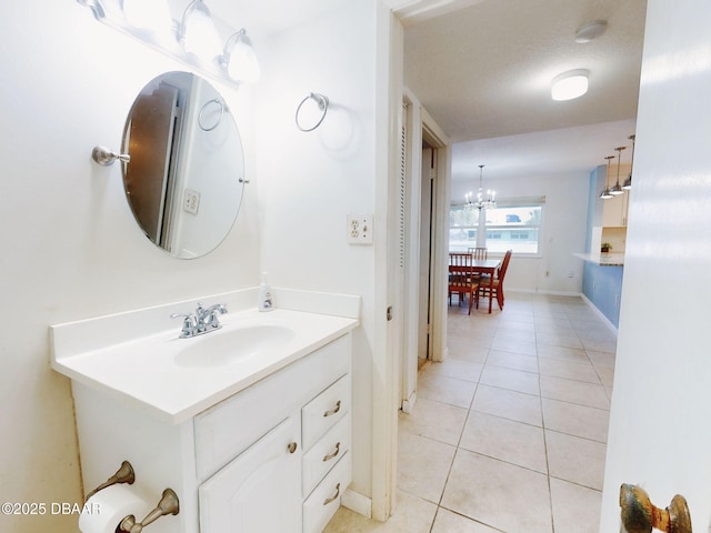 bathroom featuring vanity, tile patterned floors, a chandelier, and a textured ceiling