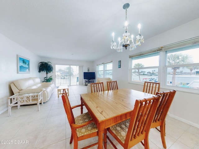 dining area featuring an inviting chandelier and light tile patterned floors