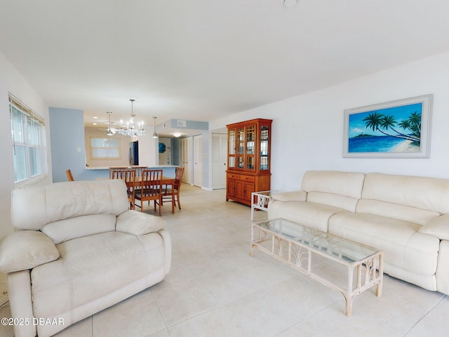 tiled living room featuring a notable chandelier