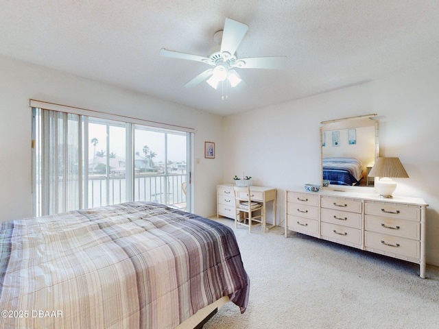 bedroom with access to outside, ceiling fan, a water view, light carpet, and a textured ceiling