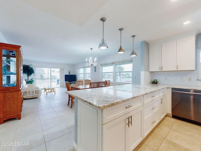 kitchen with tasteful backsplash, hanging light fixtures, dishwasher, kitchen peninsula, and white cabinets