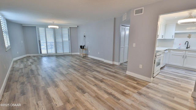 interior space featuring sink and light hardwood / wood-style floors