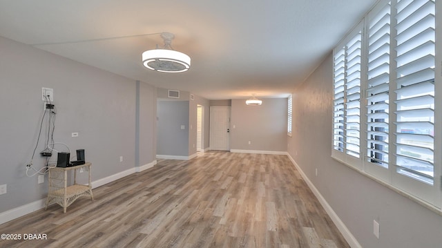 empty room featuring hardwood / wood-style flooring and a wealth of natural light