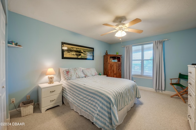 bedroom featuring light colored carpet and ceiling fan