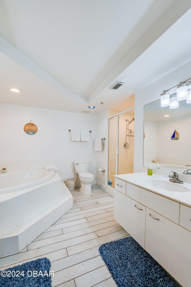 full bathroom featuring hardwood / wood-style flooring, vanity, toilet, and shower with separate bathtub