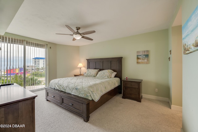 bedroom featuring access to outside, light carpet, and ceiling fan