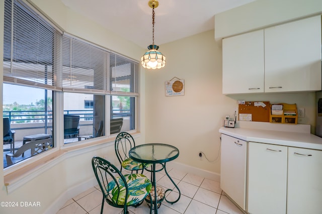 kitchen with pendant lighting, light tile patterned floors, and white cabinets