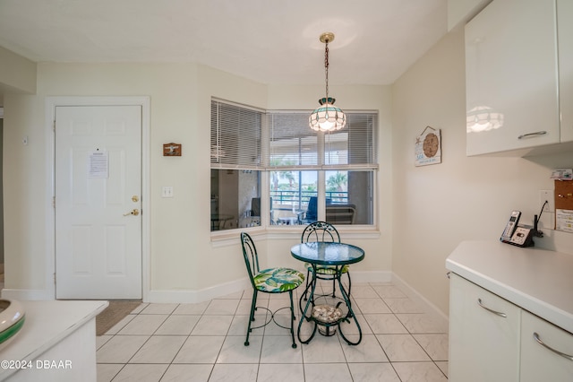 tiled dining room featuring a notable chandelier