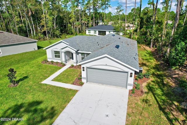 view of front of home with a garage and a front lawn