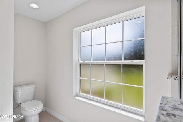 bathroom featuring tile patterned flooring and toilet